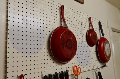 pegboard used to store pots and pans in the kitchen