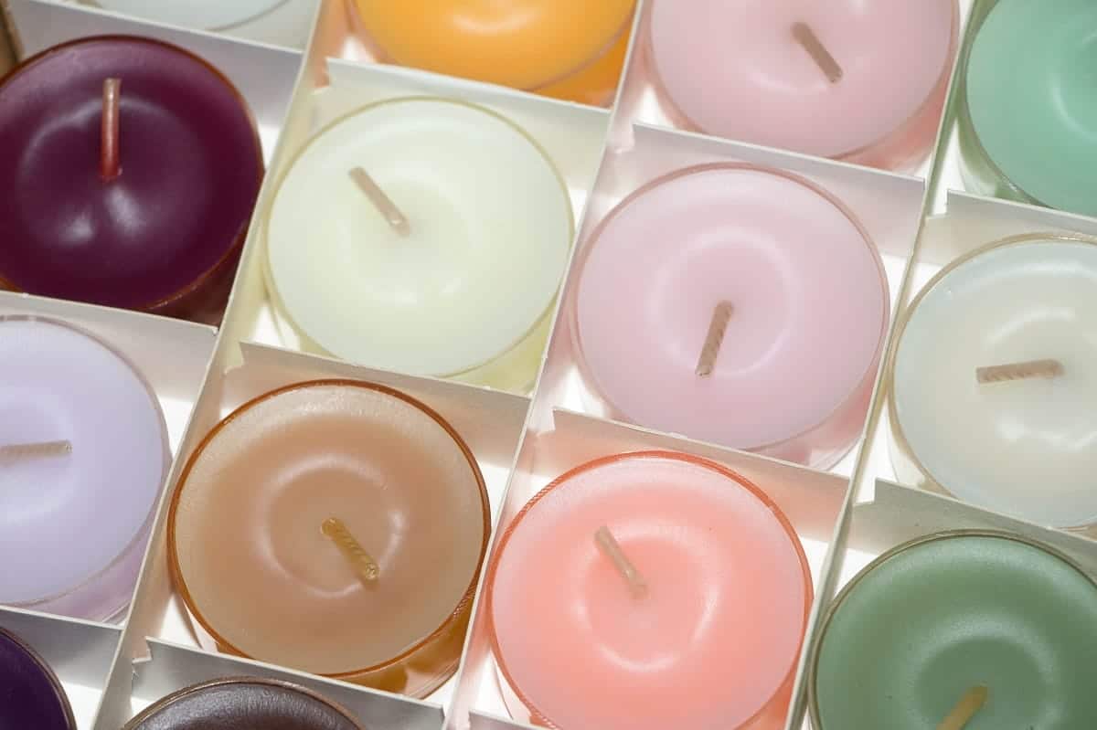 tea light candles in a box in storage unit violin sitting against a piano