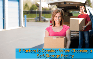 White woman with short blonde hair and pink t-shirt unloads boxes from her car at a self-storage facility.