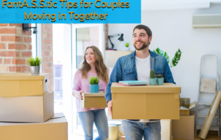 A man and a woman moving in to their new home, holding cardboard boxes.