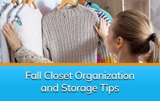 A woman looking at her sweaters hanging up after her closet organization.